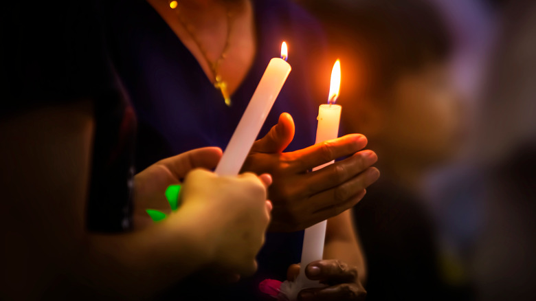 people holding candles at vigil