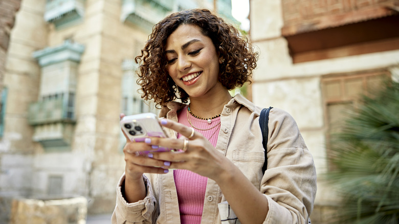 smiling woman using phone