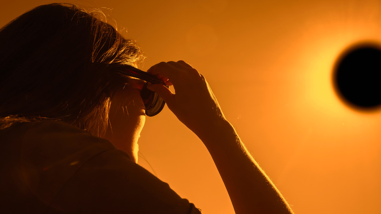 woman watching solar eclipse