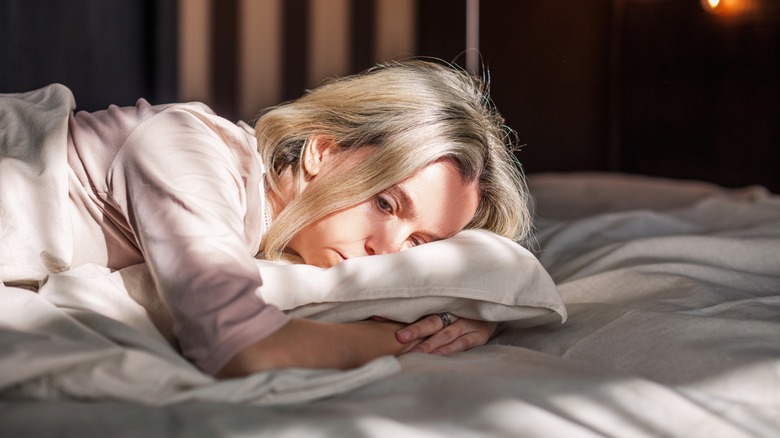 Woman sad on bed