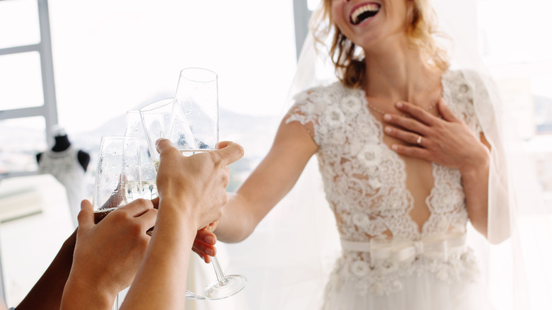 smiling bride clinking glass