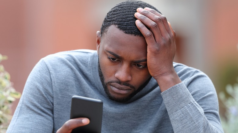 sad man on phone