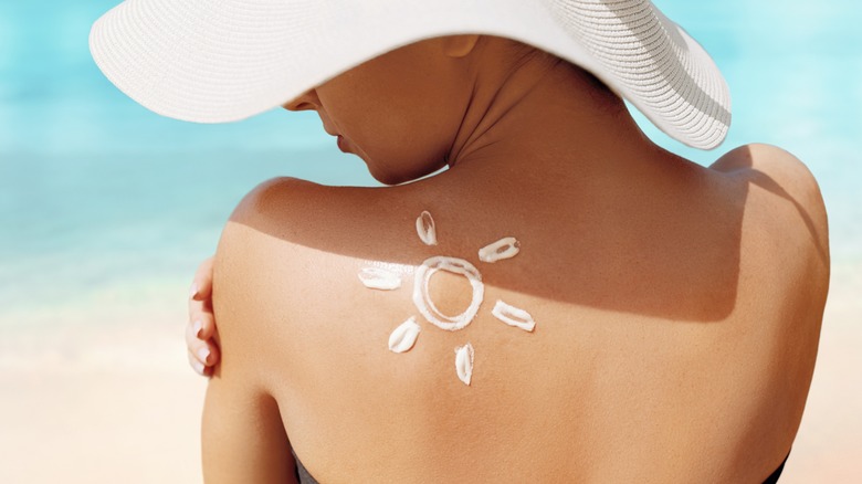 sun-shaped sunscreen on woman's back