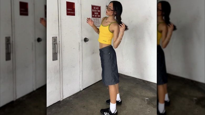 Girl yellow tank grey skirt