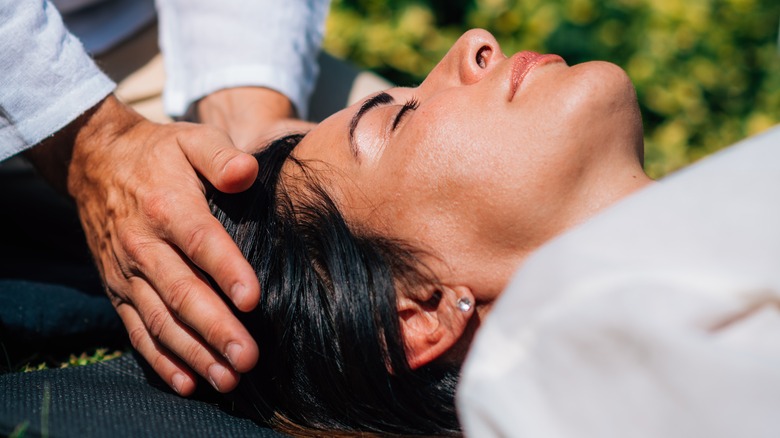 woman receiving reiki outdoors