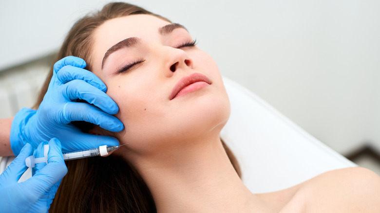 woman receiving injections in jaw