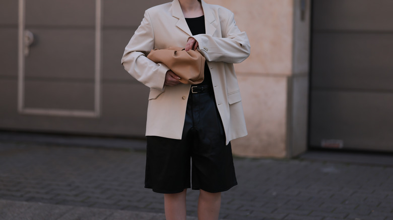 Woman wearing shorts, suit jacket