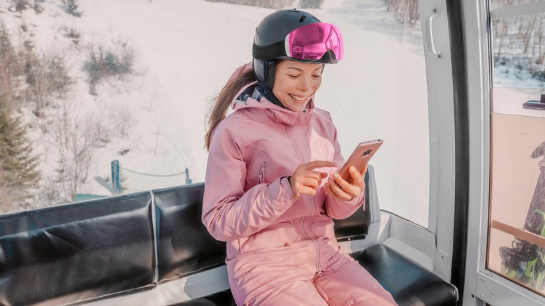 Model checking phone on ski lift