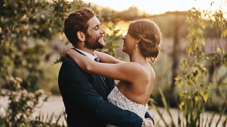 Smiling newly weds in nature