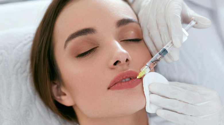 Woman getting lip filler 