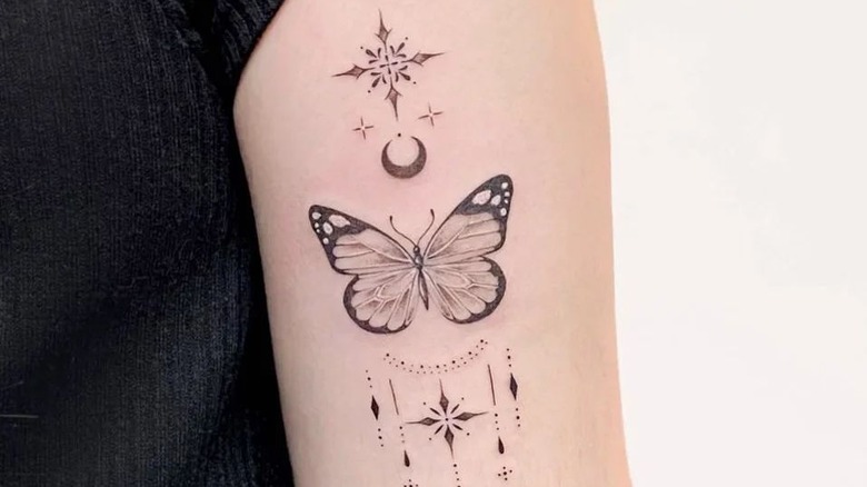 Delicate fine-line butterfly tattoo