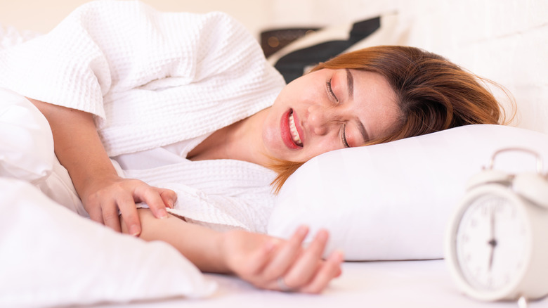 Woman sleeping with teeth showing