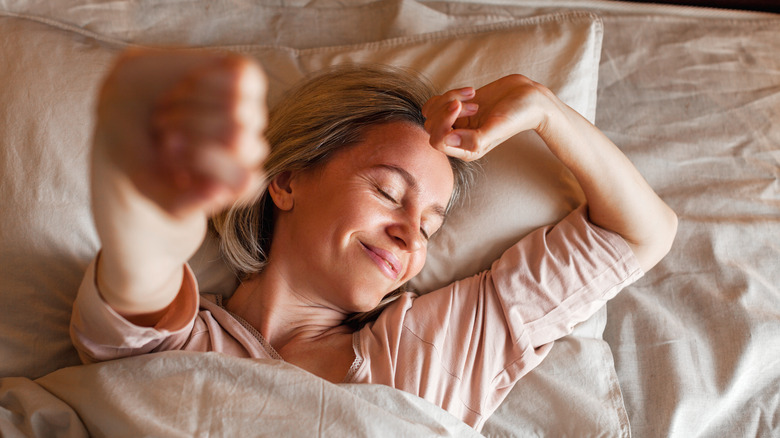 person waking up and stretching