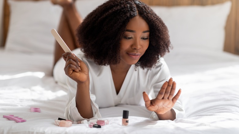 Woman filing nails