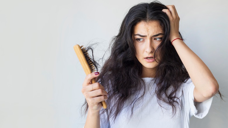 Woman with hair in brush