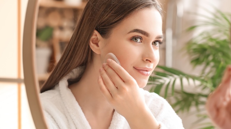 woman applying makeup