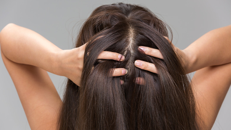 woman massaging her scalp