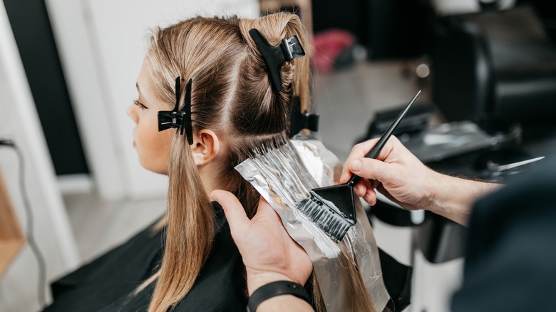 Woman getting her hair highlighted