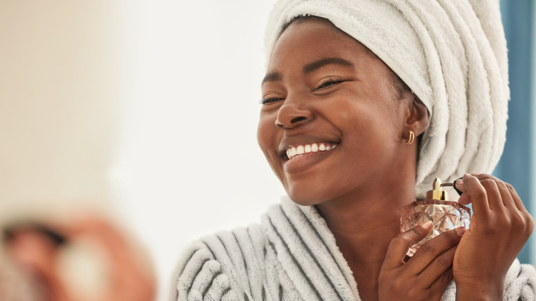 woman spraying perfume