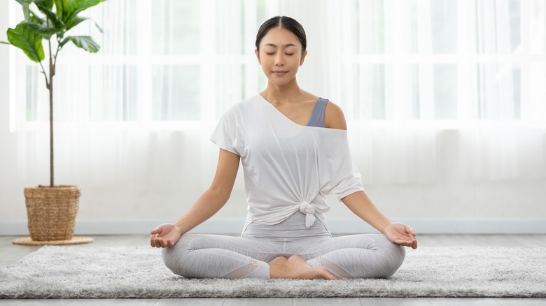 woman meditating on mat