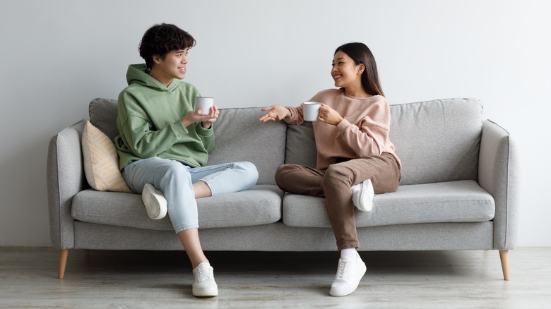 couple talking on sofa