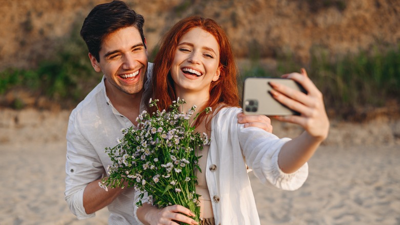 Woman takes selfie with partner
