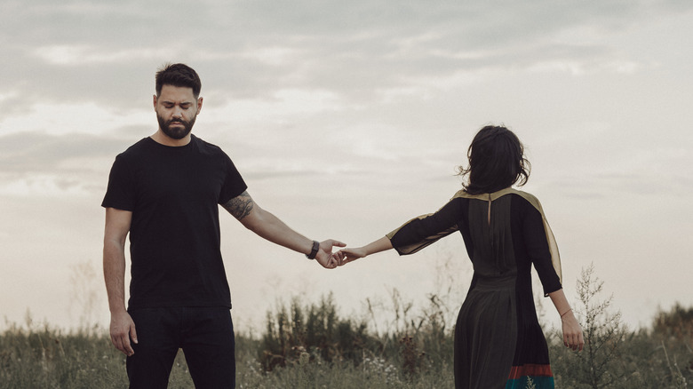 Man and woman parting in a field