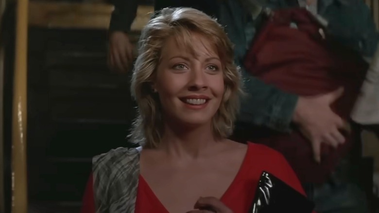 Linda Kozlowski wearing a red shirt with short hair in 
