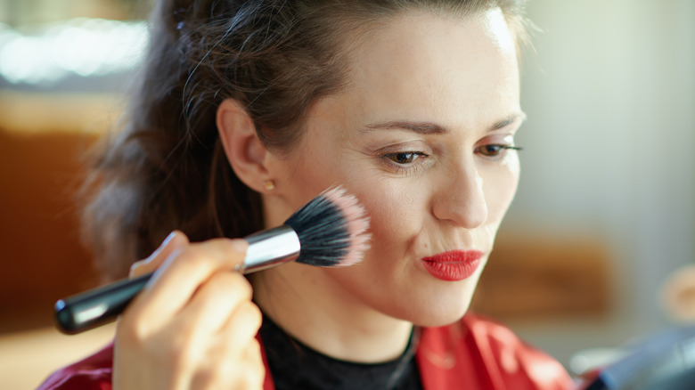 woman applying makeup