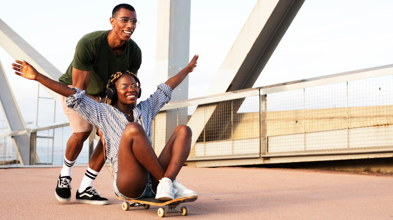 young Black couple laughing outside