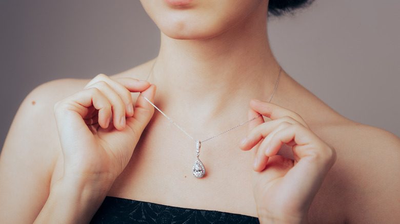 Woman models white gold pendant 