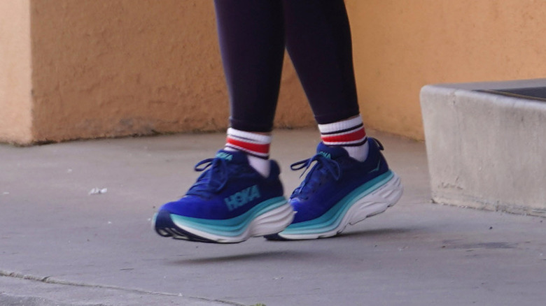 Woman wearing blue sneakers