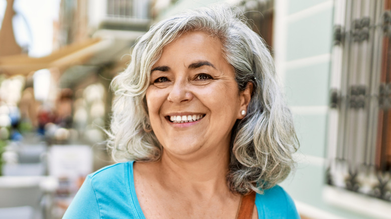 Mature woman with a wavy mid-length haircut