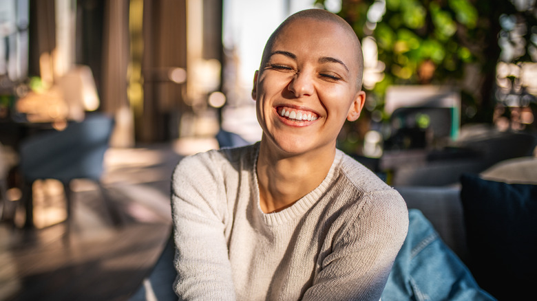 Smiling woman with shaved head