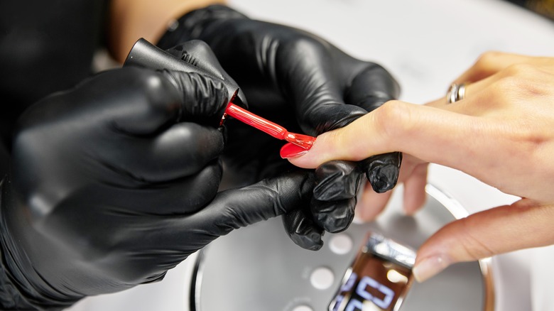 manicurist working on nails