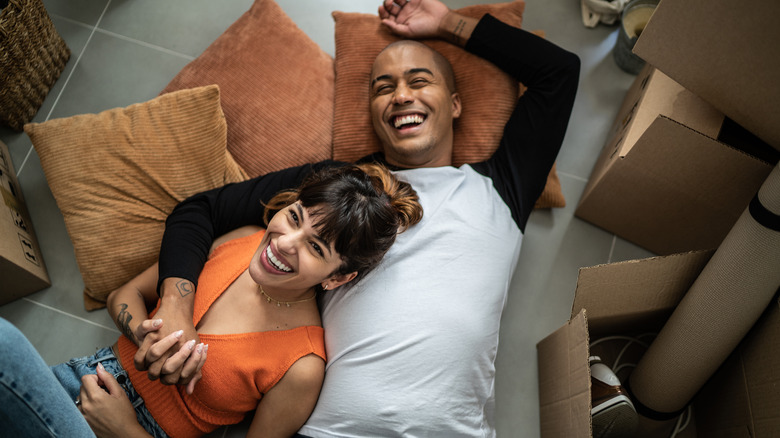 Couple laughing together in house