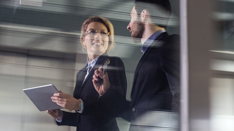 Colleagues converse in workplace
