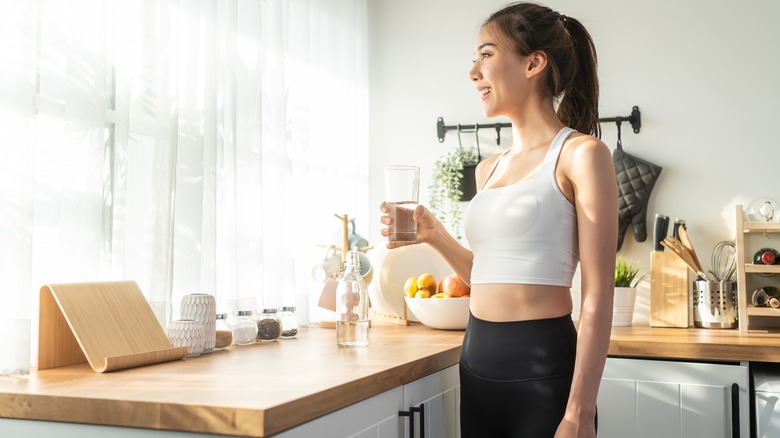 woman drinking water and fasting