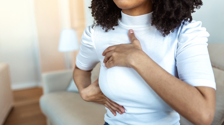 woman performing breast self-exam