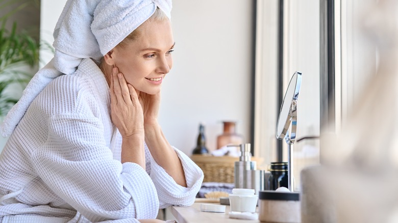 woman sitting at makeup vanity