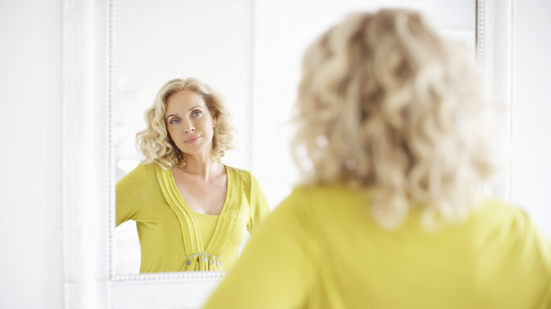 Woman looking in mirror