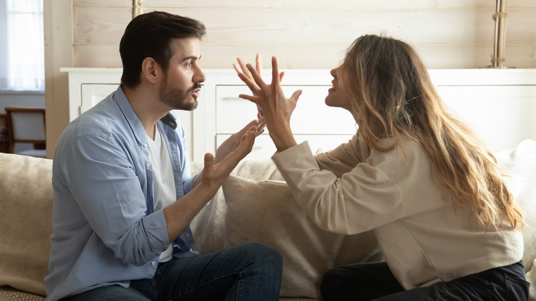 Couple arguing on the sofa