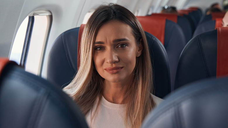 sad woman on plane