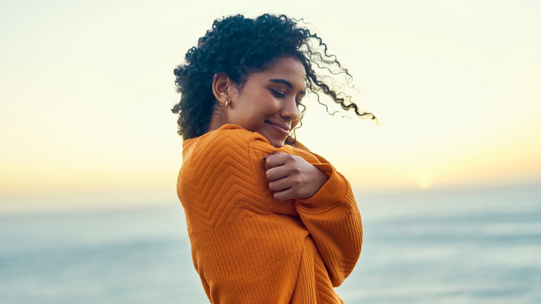 Girl hugging herself