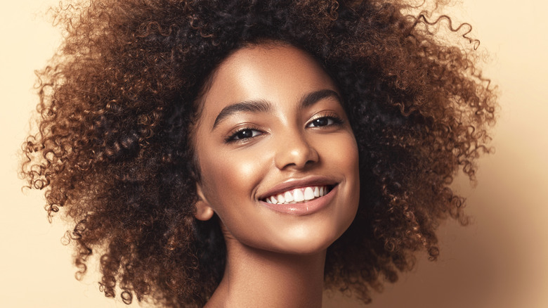 woman with curly hair smiling