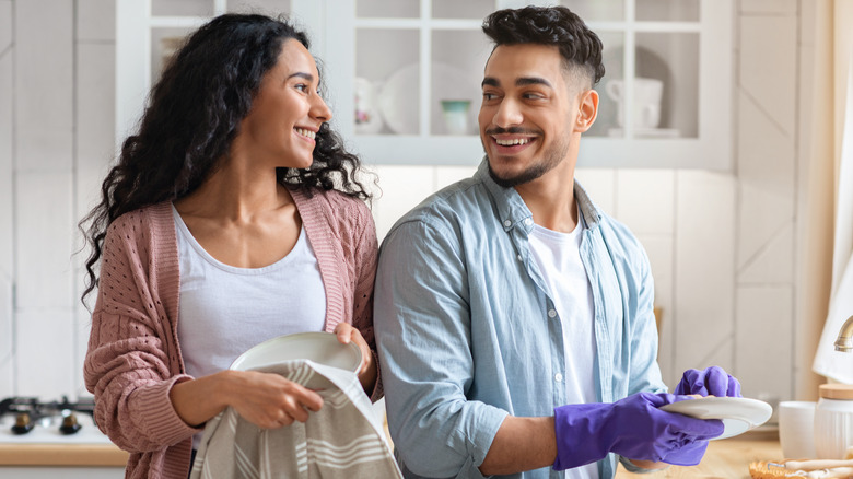 smiling couple doing dishes