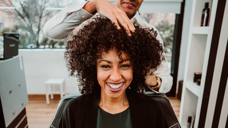 curly haired woman at salon