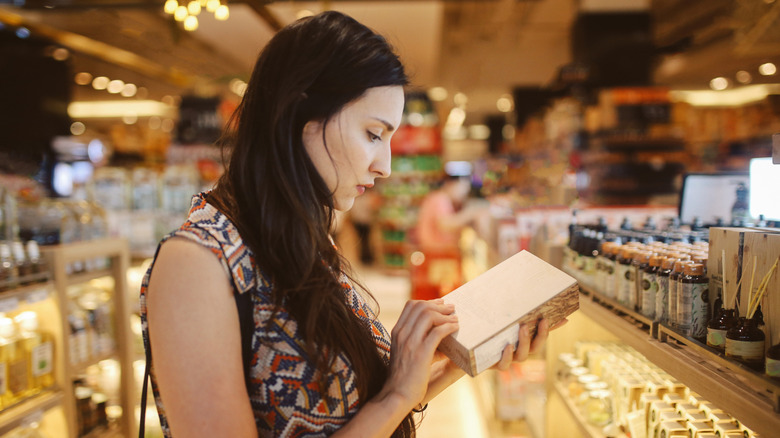 Woman reading product label