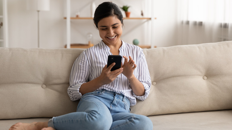 Woman smiling at her phone