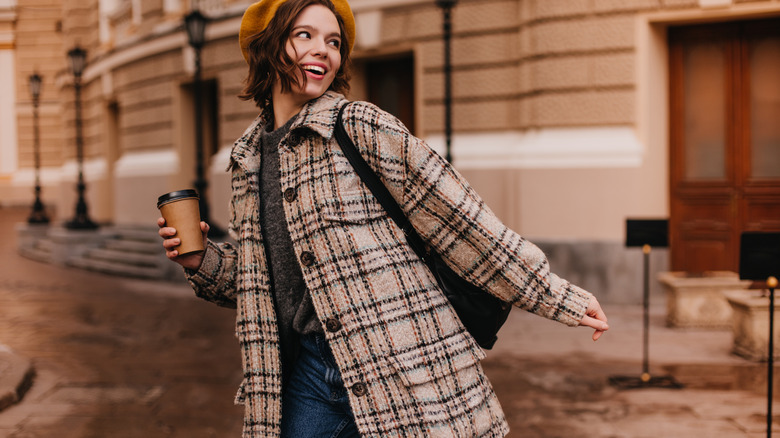 Woman wears beret and shacket over her outift